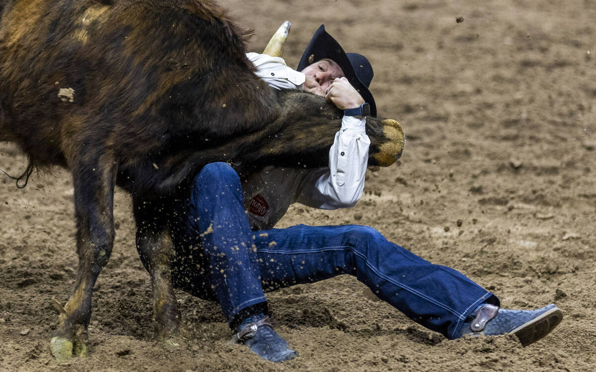 Steer wrestler Rowdy Parrott wraps up his steer for a take down during National Finals Rodeo Da ...