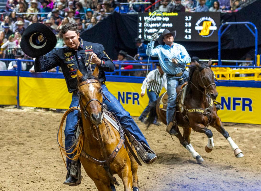 Team roping heeler Wesley Thorp, left, and header Tyler Wade take a lap after winning the event ...