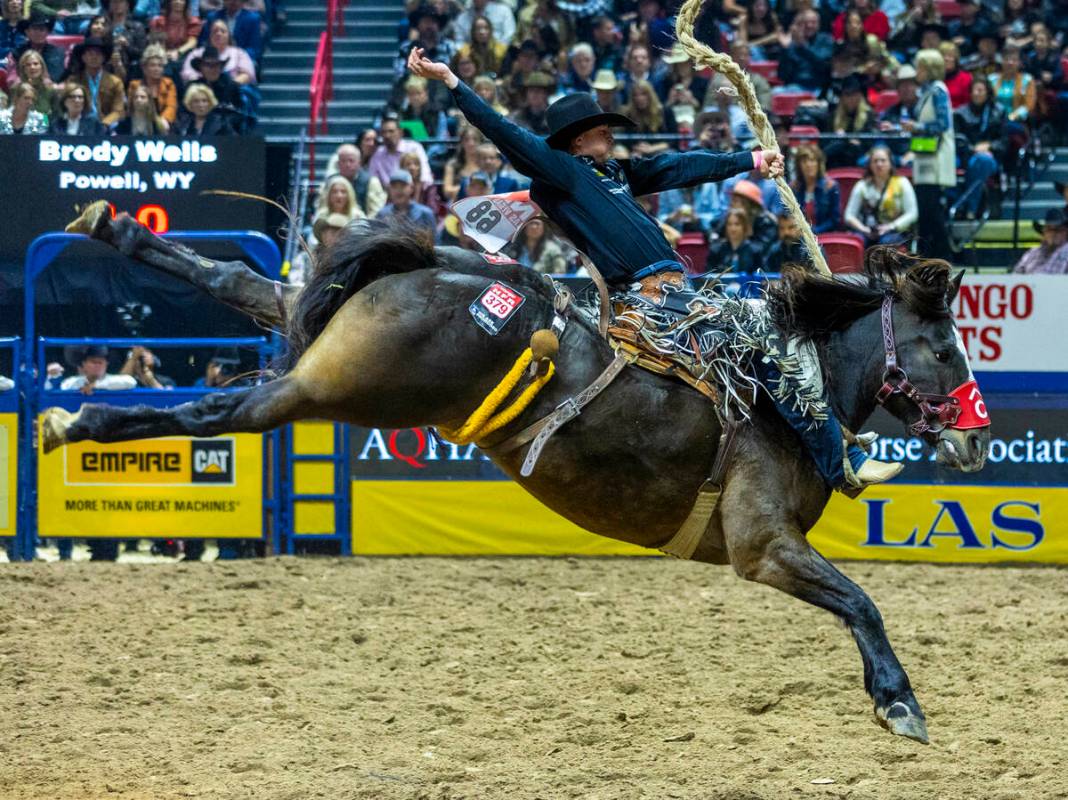 Saddle Bronc Riding competitor Brody Wells lays back on Resistol's Pretty Woman for a winning r ...