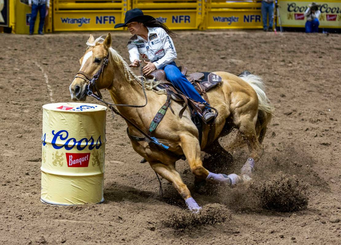 Barrel Racing competitor Hailey Kinsel navigates the first barrel on the way to a winning time ...