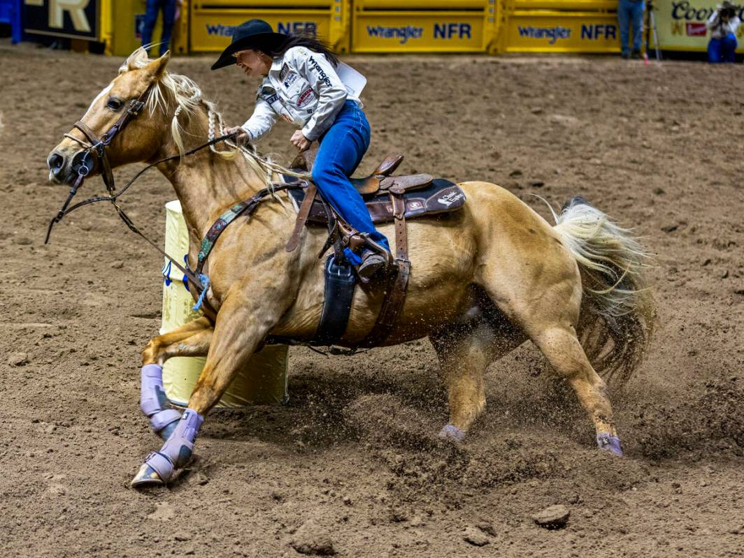 Barrel Racing competitor Hailey Kinsel navigates the first barrel on the way to a winning time ...