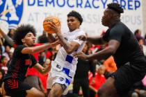 Democracy Prep forward Dion Parker (middle) glides through Mater defense during a boys basketba ...