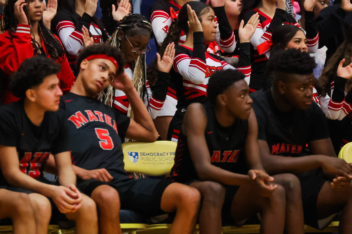 Mater East cheerleaders continue to cheer as their team is down during a boys basketball game b ...