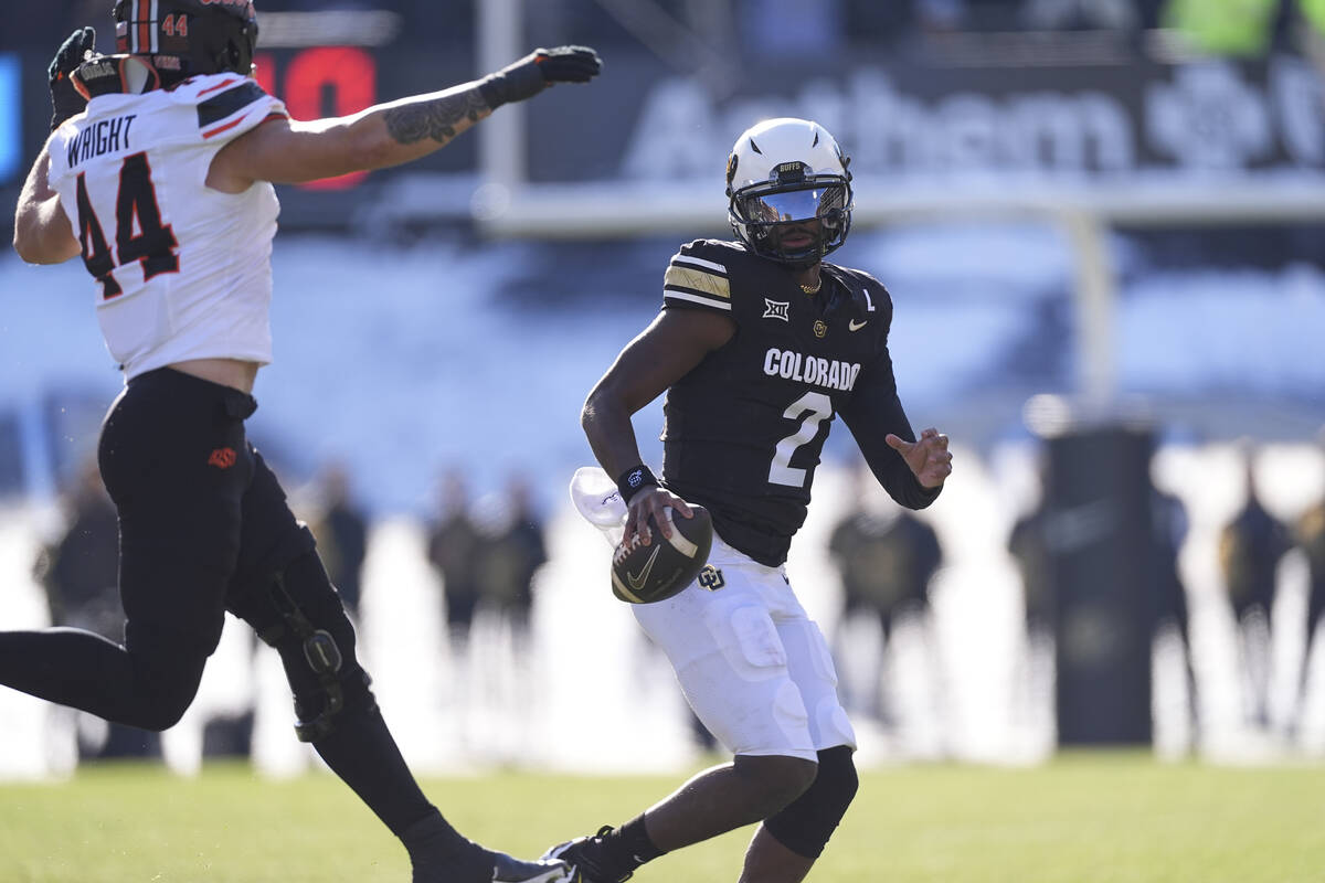 Colorado quarterback Shedeur Sanders (2) and Oklahoma State linebacker Justin Wright (44) in th ...