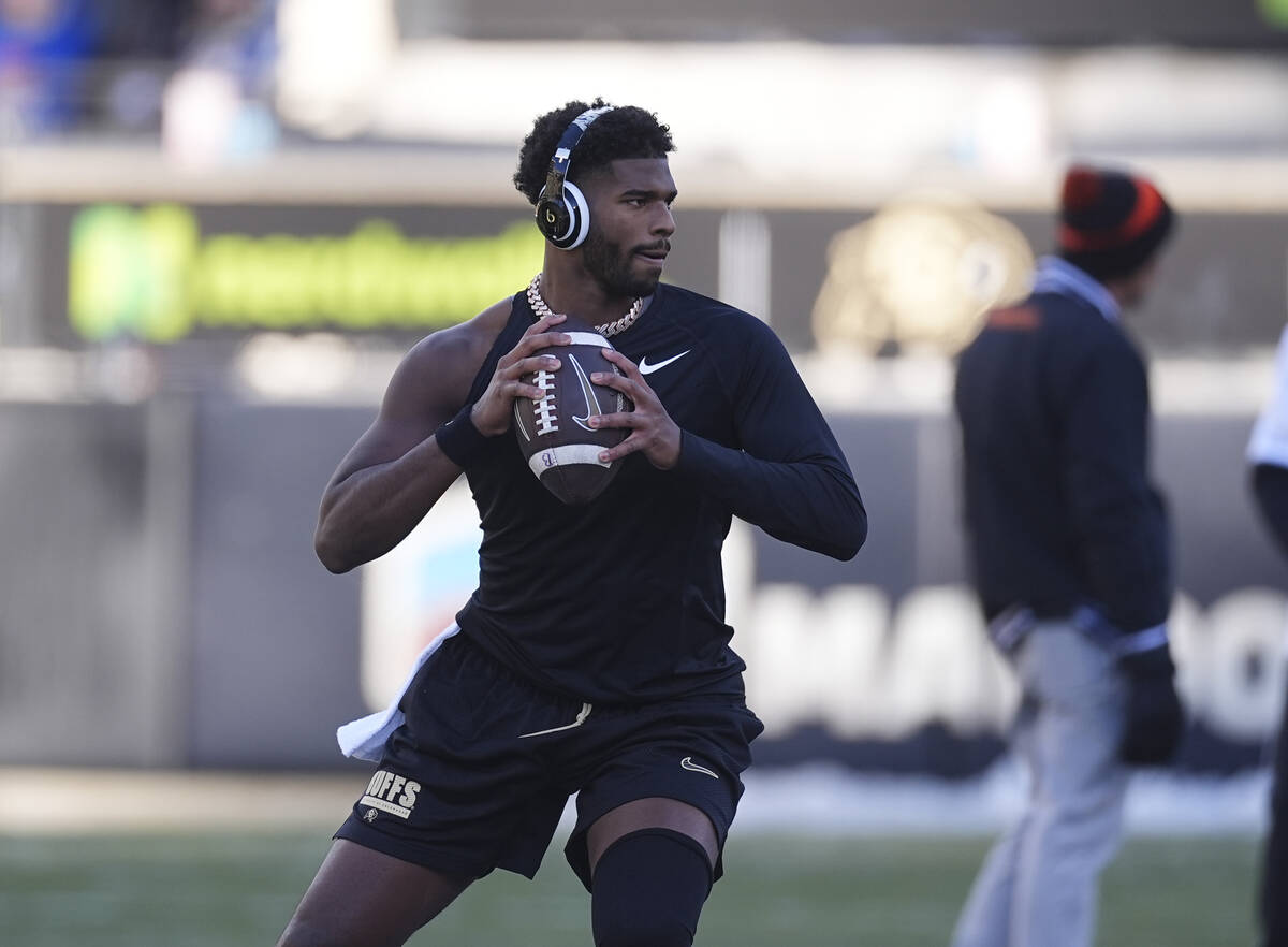 Colorado quarterback Shedeur Sanders (2) warms up before an NCAA college football game Friday, ...