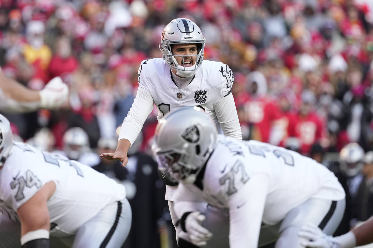 Las Vegas Raiders quarterback Aidan O'Connell sets up the offense during an NFL football game a ...