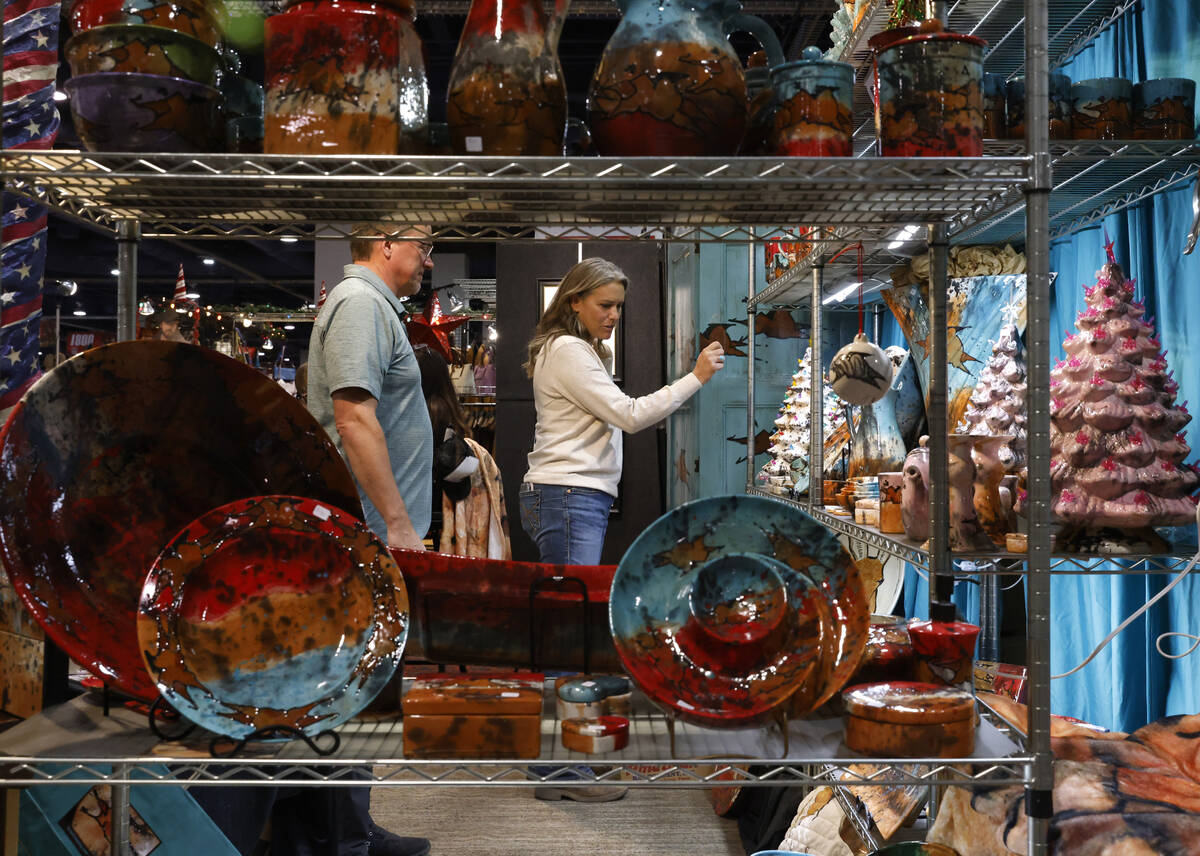 Shoppers check out ceramic artwork at the Orion Crossing booth at Cowboy Christmas at the Las V ...