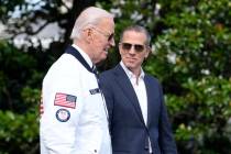 FILE - President Joe Biden, wearing a Team USA jacket and walking with his son Hunter Biden, he ...