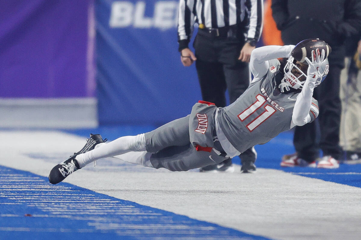 UNLV wide receiver Ricky White III (11) catches the ball on the sideline against Boise State in ...