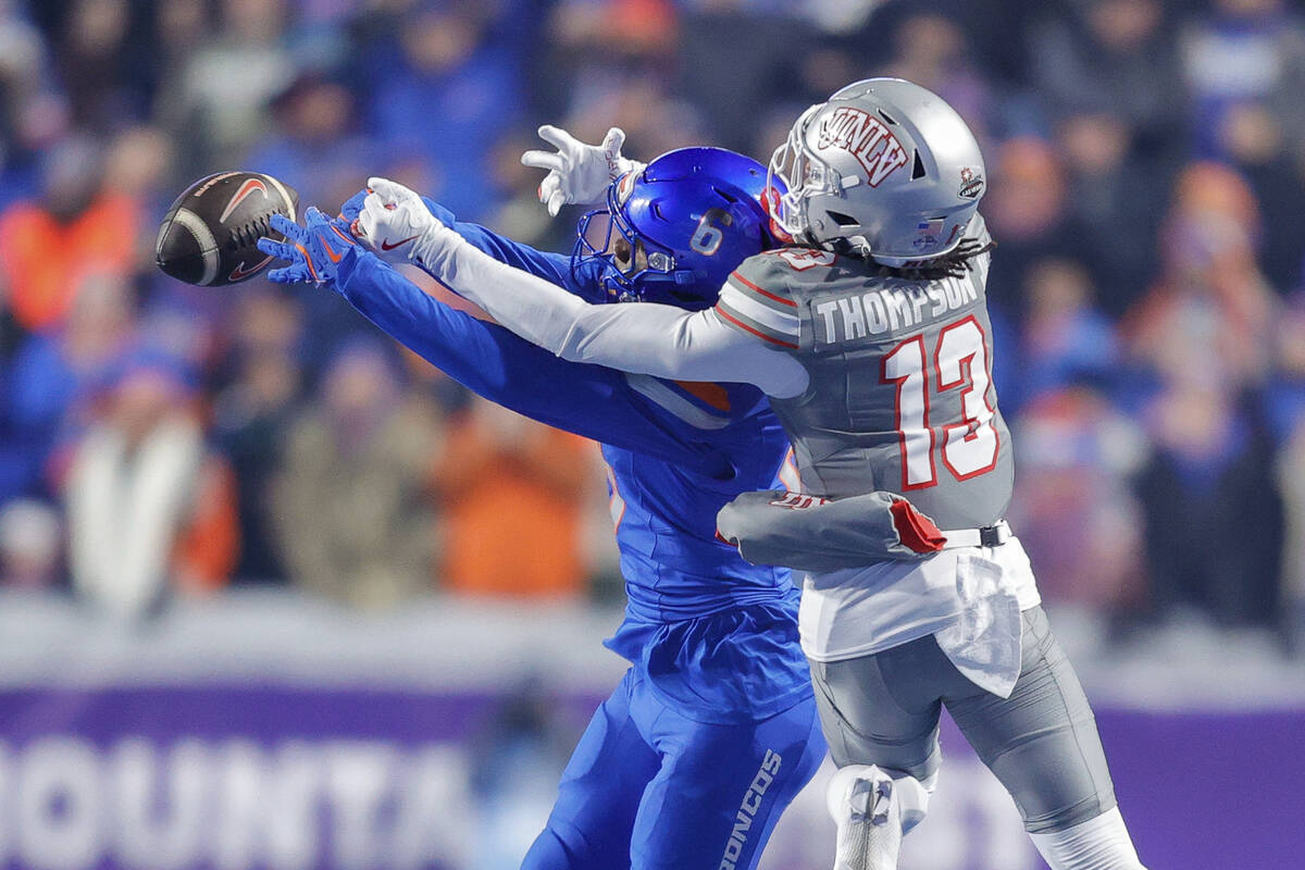 Boise State cornerback Jeremiah Earby, left, breaks up a pass to UNLV wide receiver Corey Thomp ...