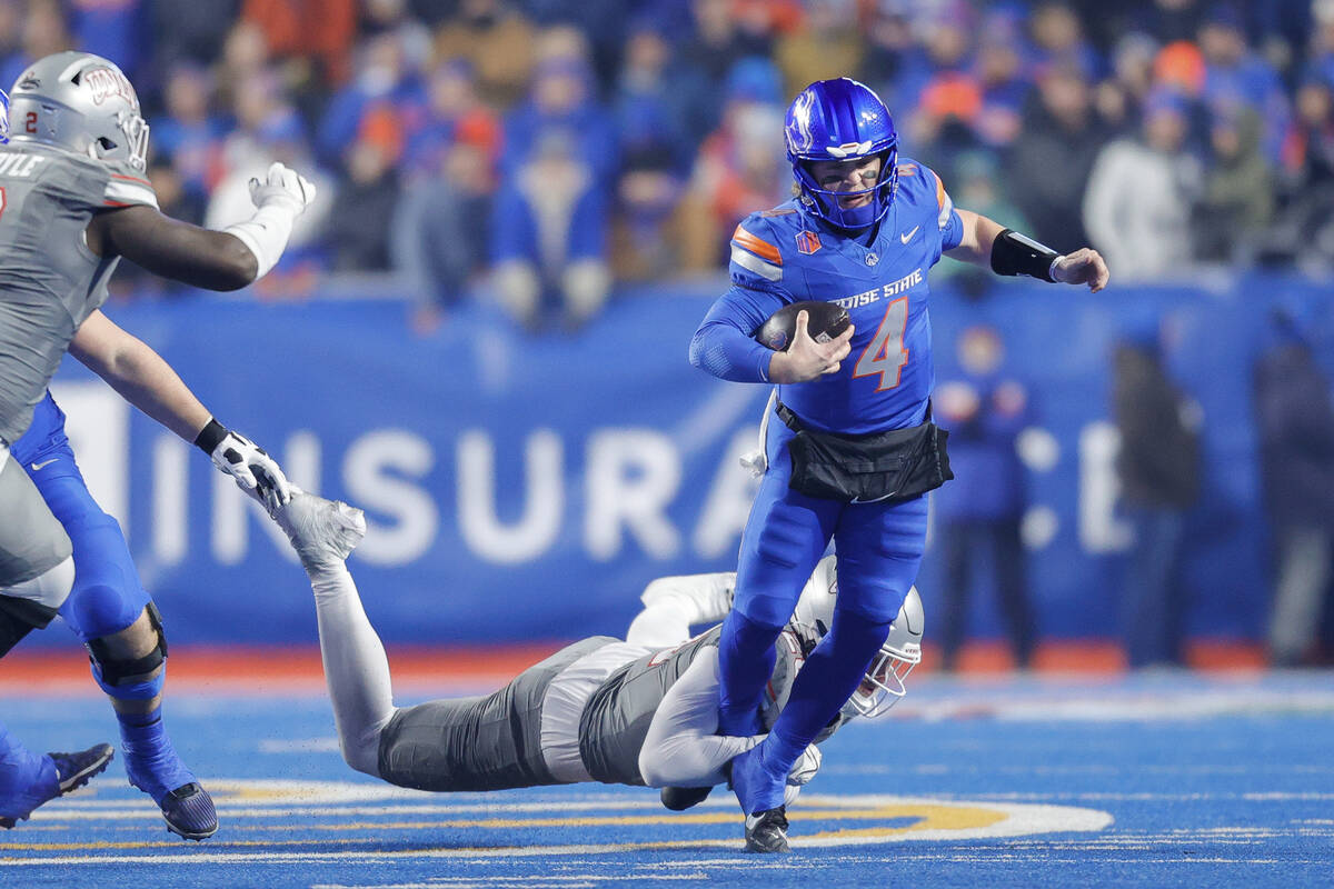 Boise State quarterback Maddux Madsen (4) is tripped by a UNLV defender on a scramble in the fi ...