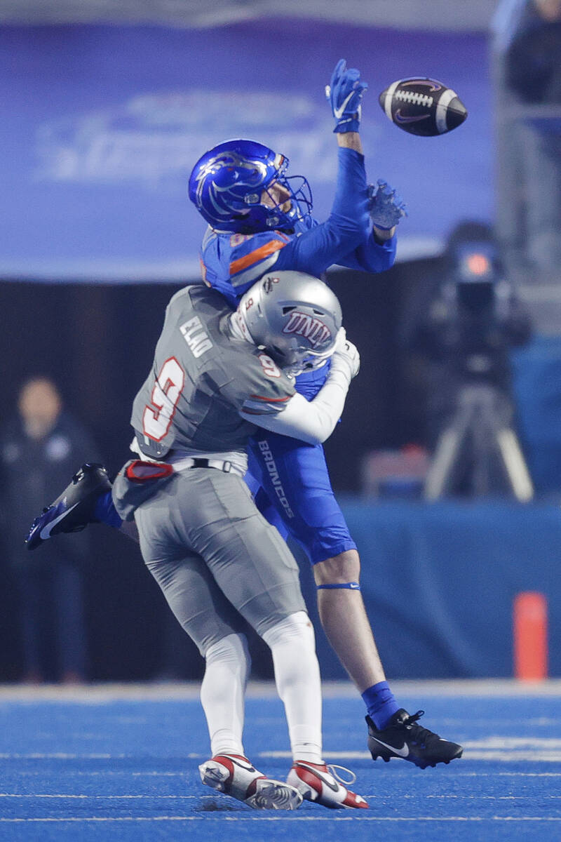 UNLV defensive back Jett Elad (9) hits Boise State wide receiver Austin Bolt (81) to break up a ...