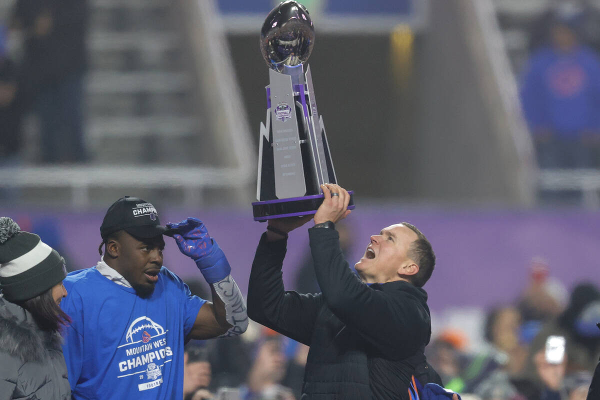 Boise State head coach Spencer Danielson celebrates with safety Seyi Oladipo, the defensive pla ...