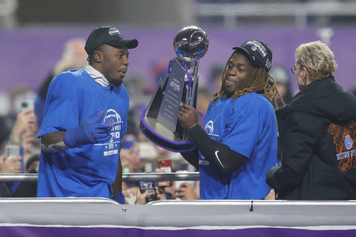 Boise State safety Seyi Oladipo, left, the defensive player of the game, and running back Ashto ...