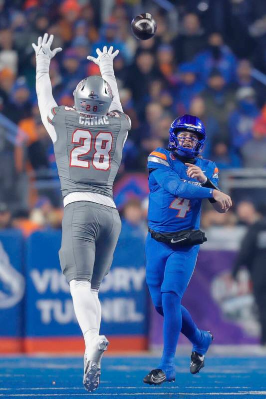 Boise State quarterback Maddux Madsen (4) throws the ball over UNLV defensive lineman Fisher Ca ...