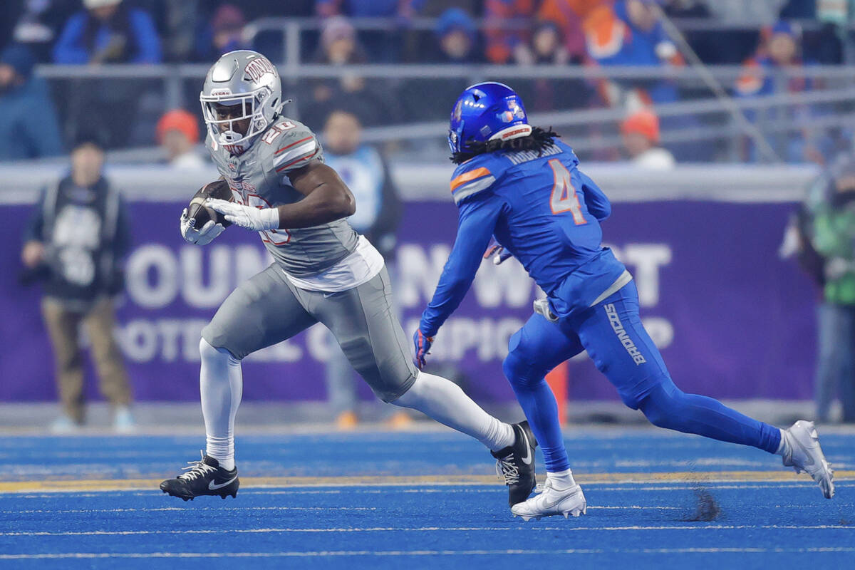 UNLV running back Kylin James (20) runs the ball as Boise State safety Rodney Robinson (4) defe ...