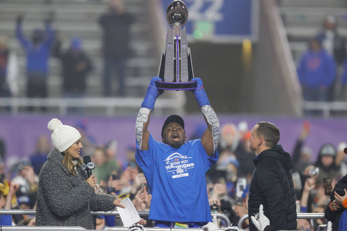 Boise State safety Seyi Oladipo, the defensive player of the game, celebrates with the Champion ...