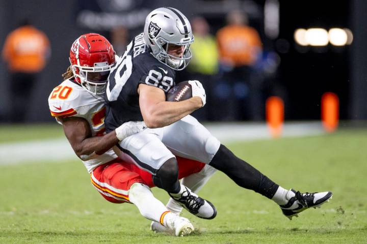 Raiders tight end Brock Bowers (89) is tackled by Kansas City Chiefs safety Justin Reid (20) du ...