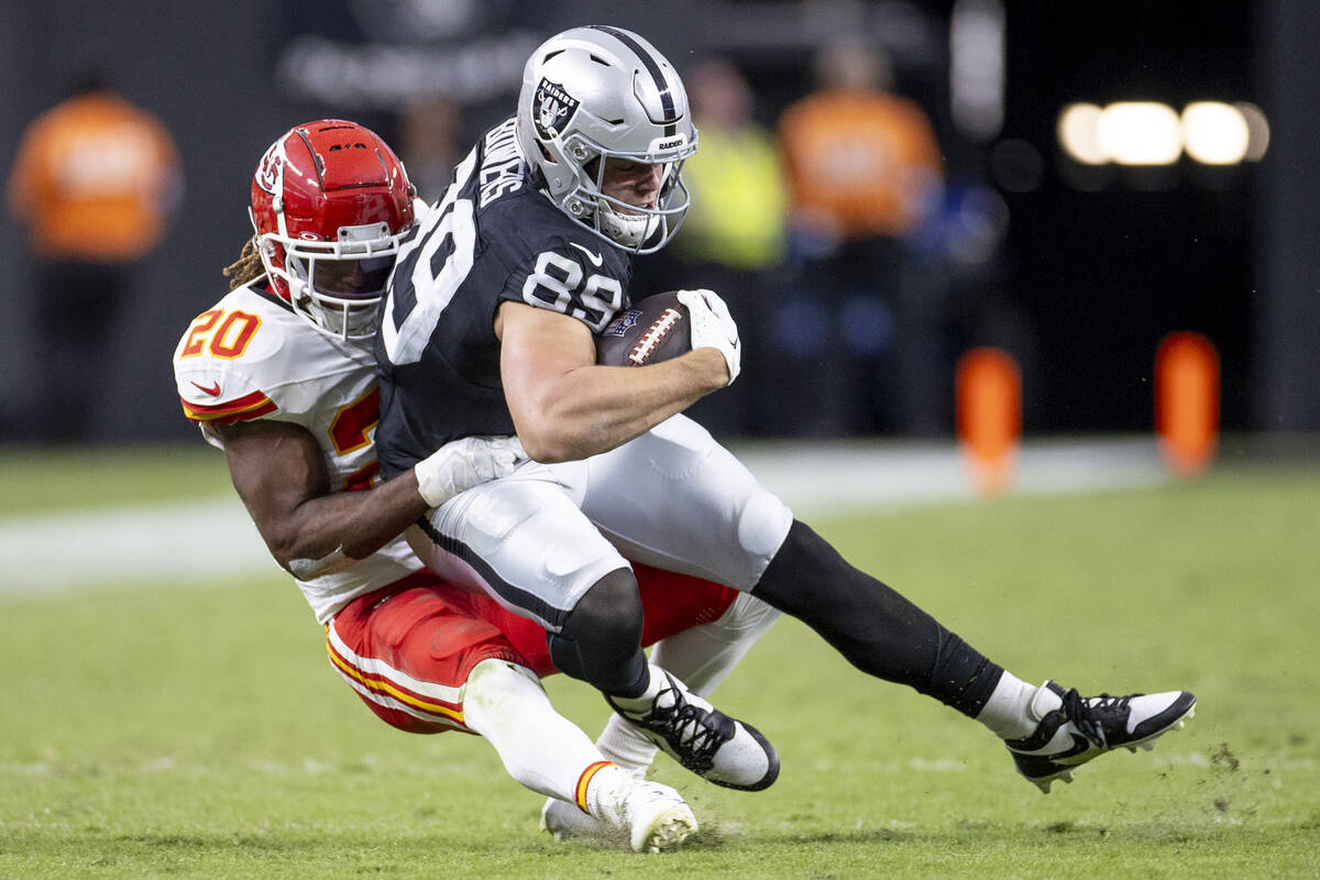 Raiders tight end Brock Bowers (89) is tackled by Kansas City Chiefs safety Justin Reid (20) du ...