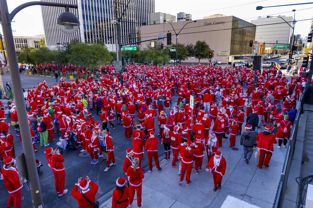 Entrants gather about E. Bridger Avenue and the start line for the Las Vegas Great Santa Run th ...