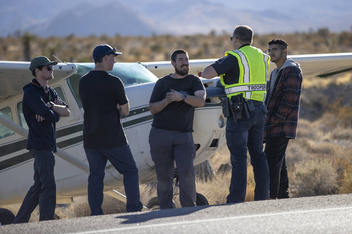 A crew of men, who declined to give their names, talk to Nevada Highway Patrol trooper Roy Eric ...