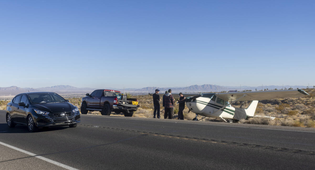 People drive by a plane that emergency landed on Kyle Canyon Road, Saturday, Dec. 7, 2024, in L ...