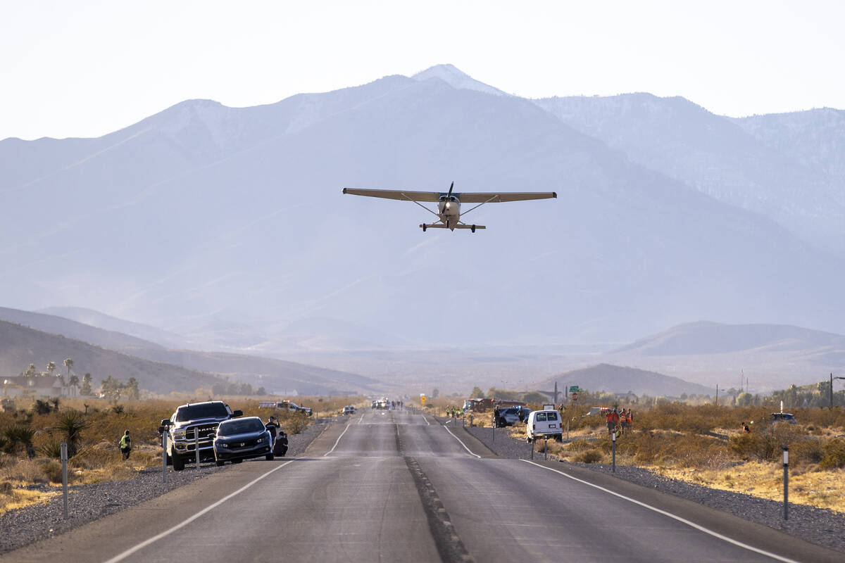 A plane successfully takes flight after it emergency landed on Kyle Canyon Road, Saturday, Dec. ...