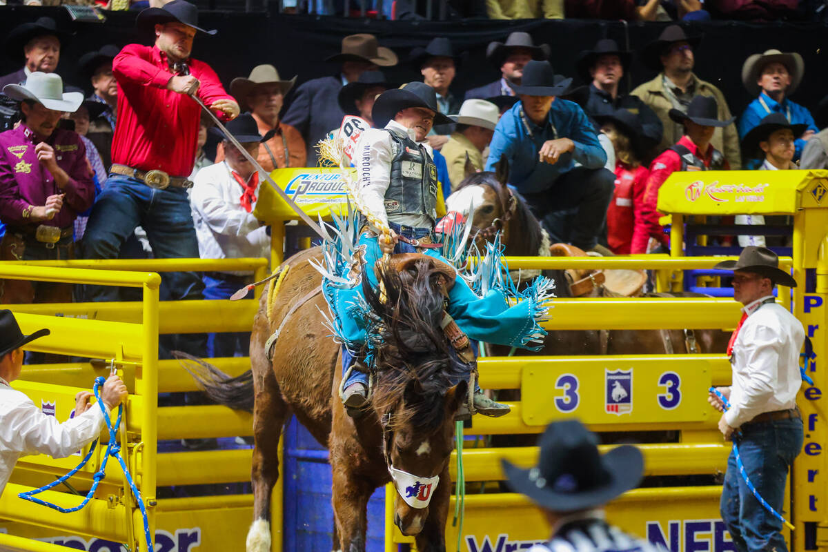 Saddle Bronc rider Sage Newman breaks out of the chute during round three of the National Final ...