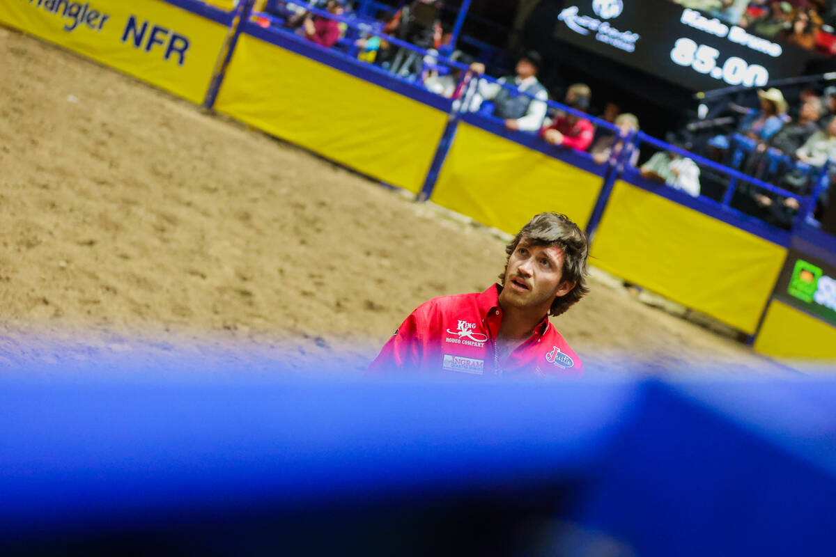 Saddle bronc rider Kade Bruno looks at his score during round three of the National Finals Rode ...