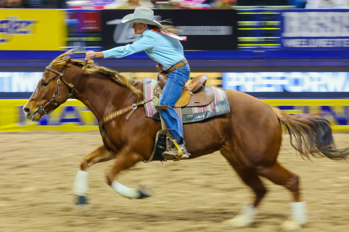 Barrel racer Lisa Lockhart races out of the arena during round three of the National Finals Rod ...