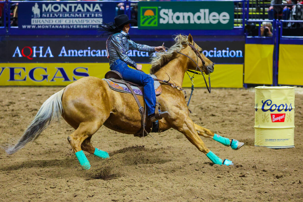 Barrel racer LaTricia Duke races around a barrel during round three of the National Finals Rode ...