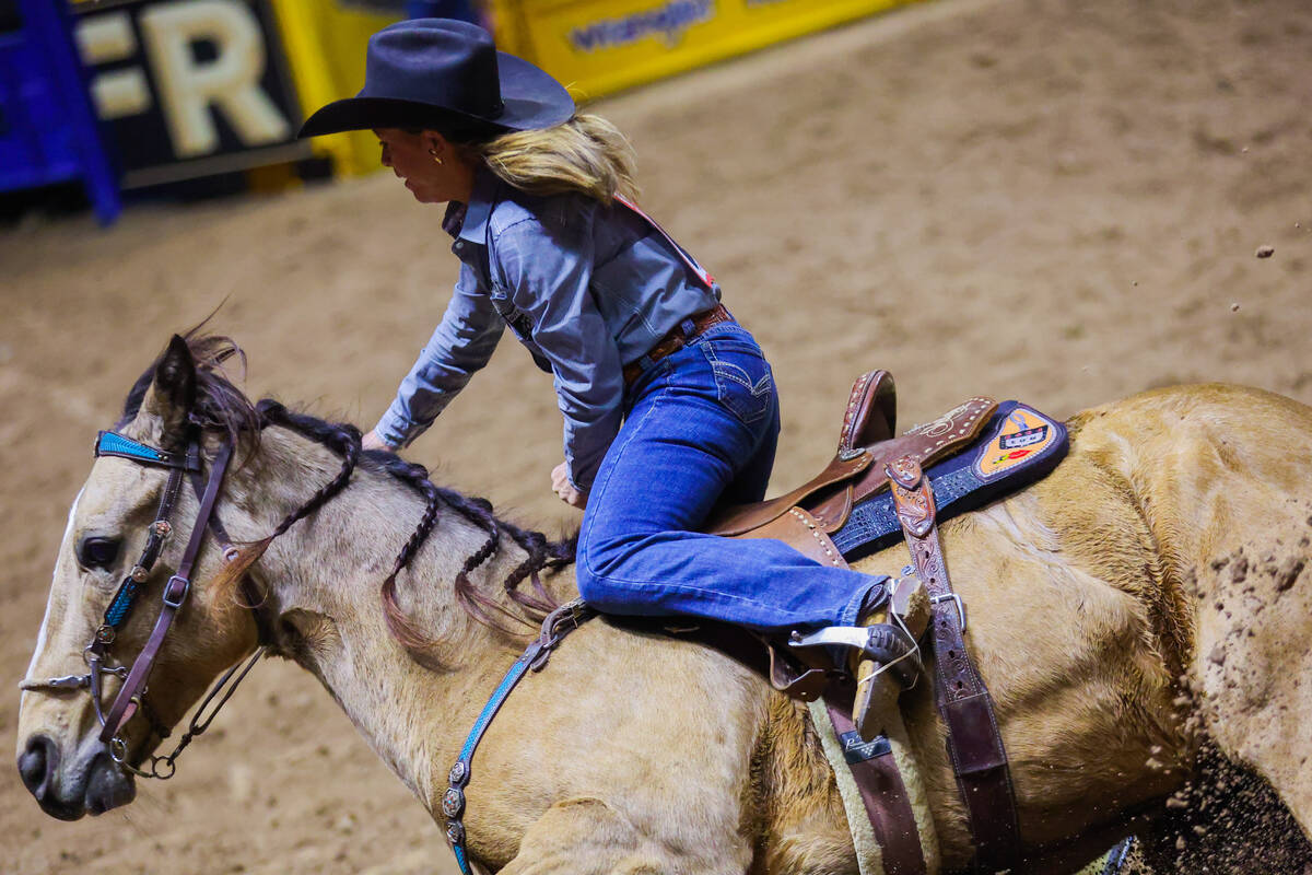 Barrel racer Shelley Morgan rounds a barrel during round three of the National Finals Rodeo at ...