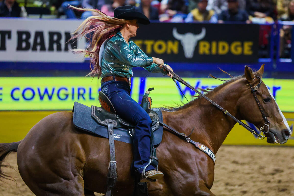 Barrel racer Leslie Smalygo races into the arena during round three of the National Finals Rode ...