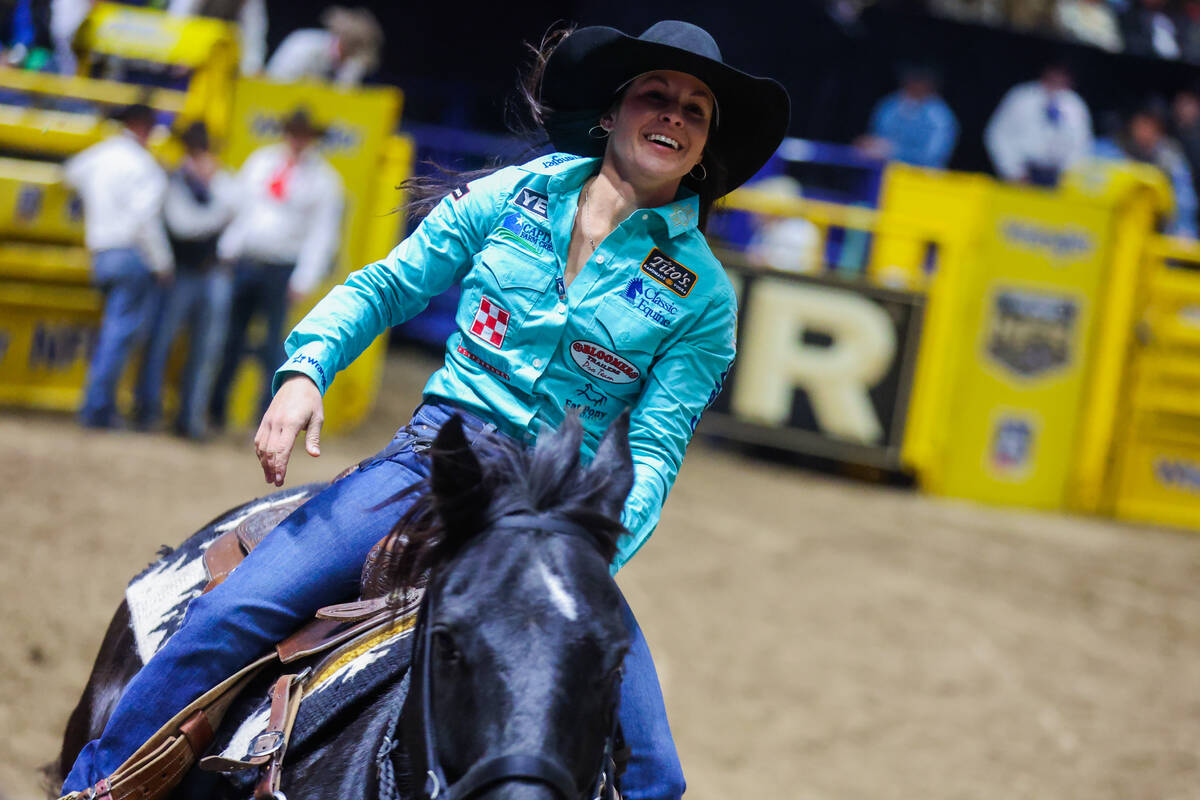 Barrel racer Hailey Kinsel takes her victory lap during round three of the National Finals Rode ...