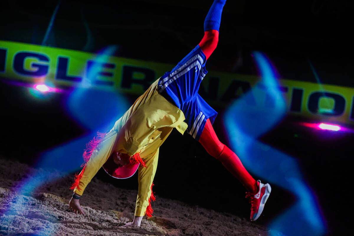 A rodeo clown does a handstand during round three of the National Finals Rodeo at the Thomas &a ...