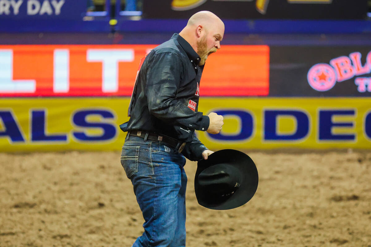 Steer wrestler Will Lummus celebrates his time during round three of the National Finals Rodeo ...