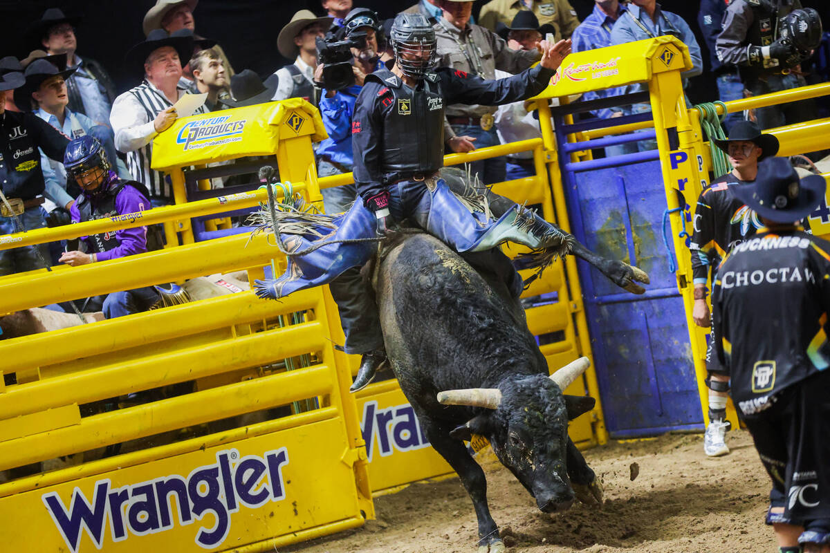 Bull rider Tyler Bingham breaks out of the chute during round three of the National Finals Rode ...