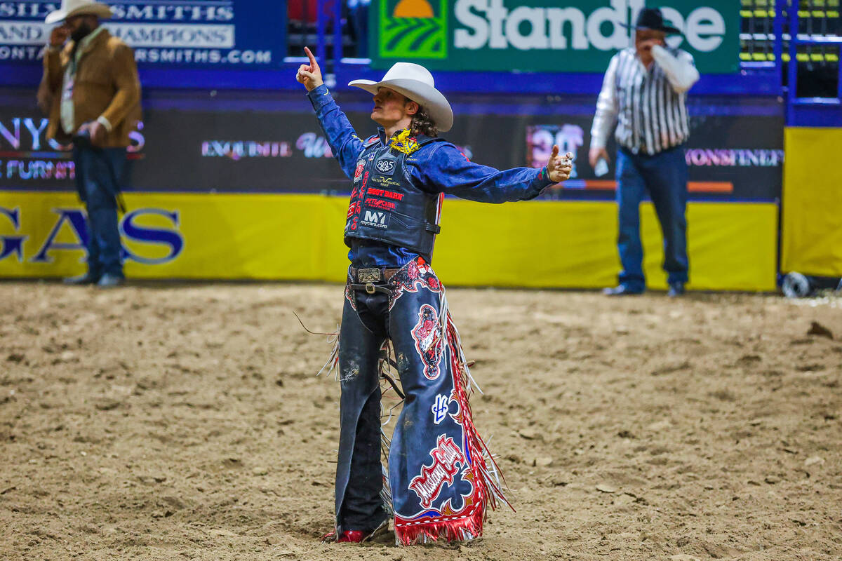 Saddle bronc rider Lefty Holman celebrates his ride during round four of the National Finals Ro ...