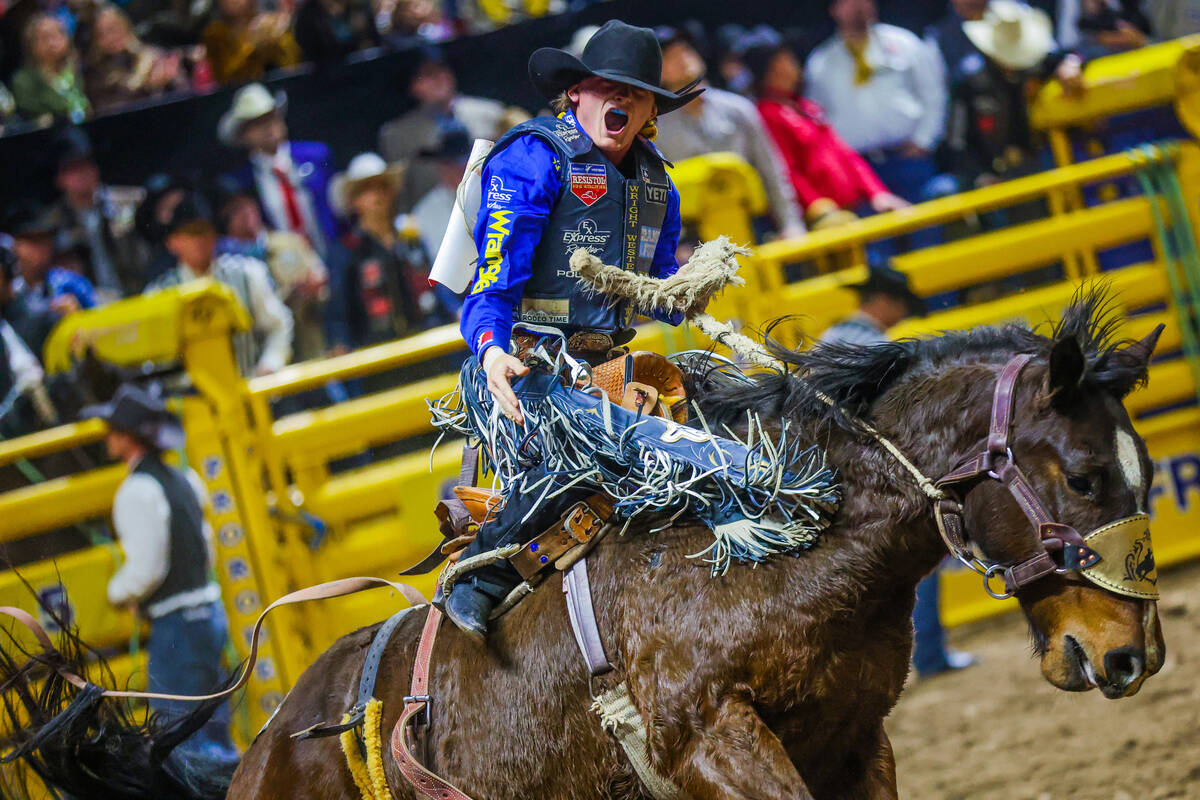 Saddle bronc rider Ryder Wright gets amped up during his ride on Tickled Pink during round four ...