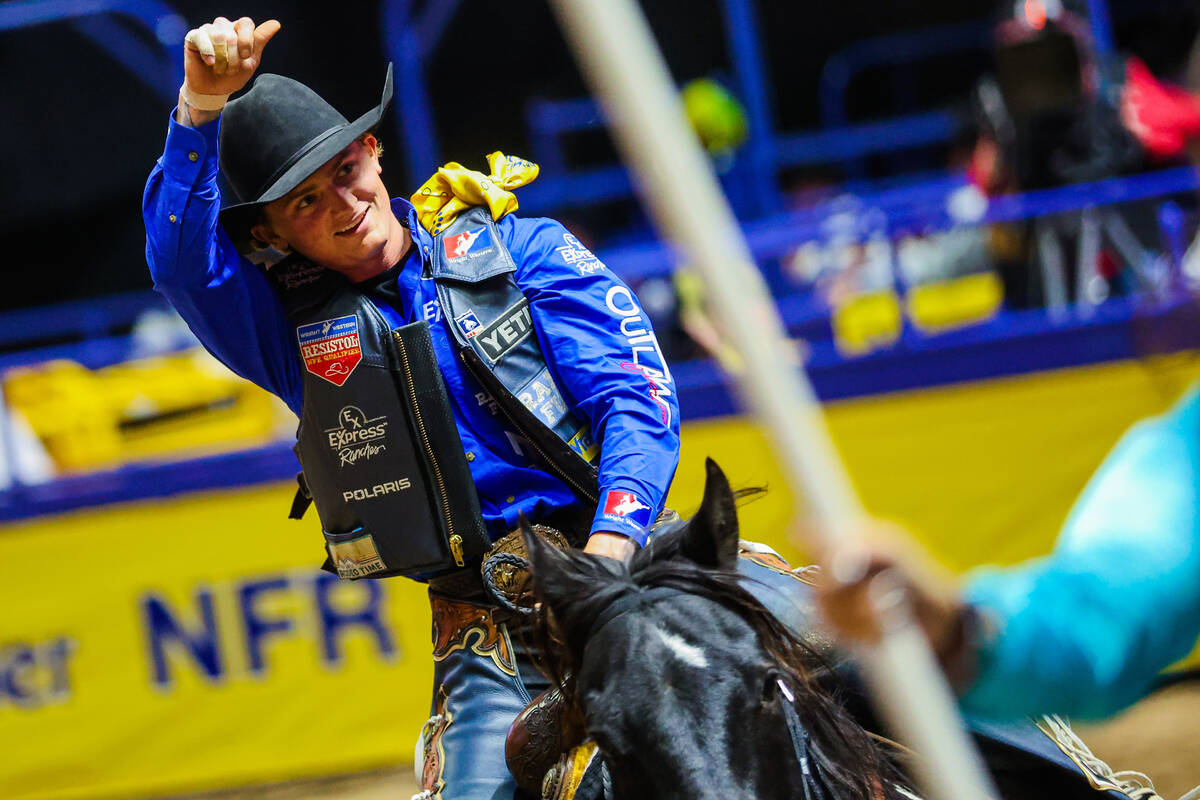 Saddle bronc rider Ryder Wright celebrates during his victory lap during round four of the Nati ...