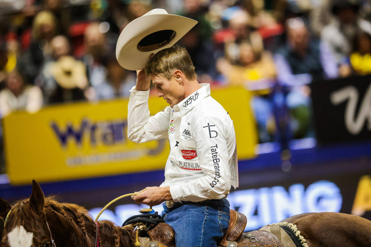 Tie-down Tuf Cooper tips his hat to the crowd during round four of the National Finals Rodeo at ...