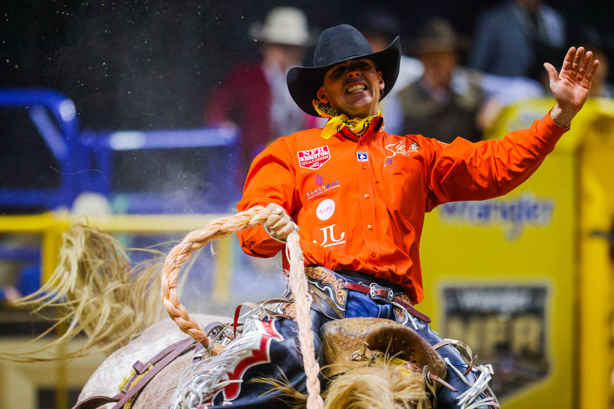 Saddle bronc rider Damian Brennan hangs on during his re-ride on Kay’s Big Day during ro ...