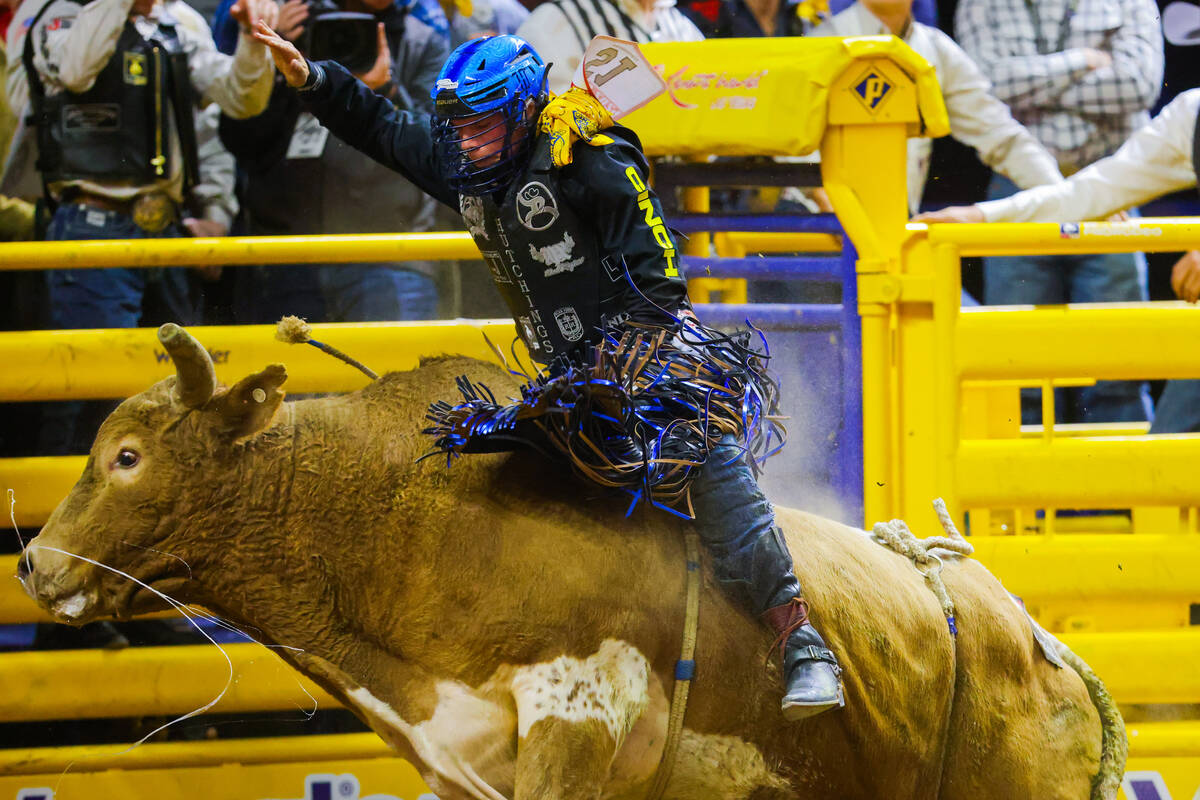 Bull rider Tristen Hutchings rides Macho Man during round four of the National Finals Rodeo at ...