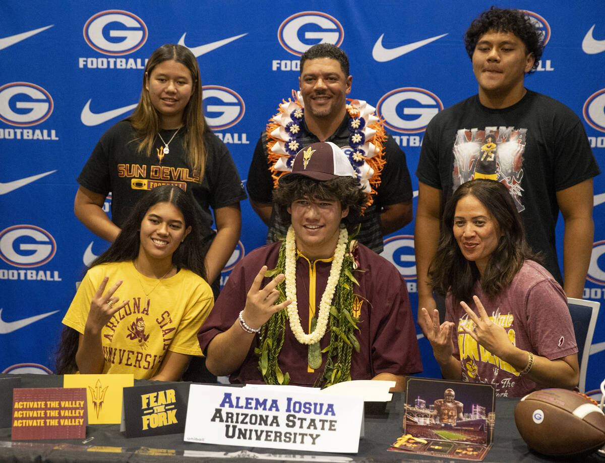 Bishop Gorman offensive tackle Alema Iosua, center, signs a financial aid agreement with Arizon ...