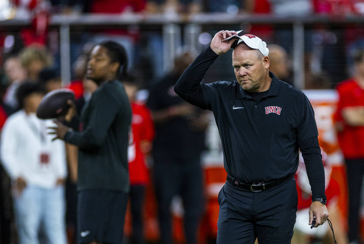 UNLV football coach Barry Odom watches his players during warm ups of their NCAA football game ...