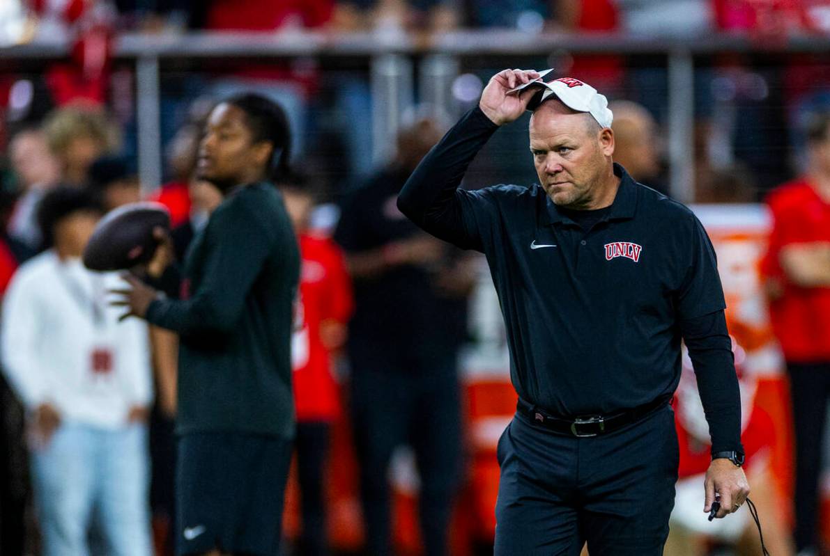 UNLV football coach Barry Odom watches his players during warm ups of their NCAA football game ...