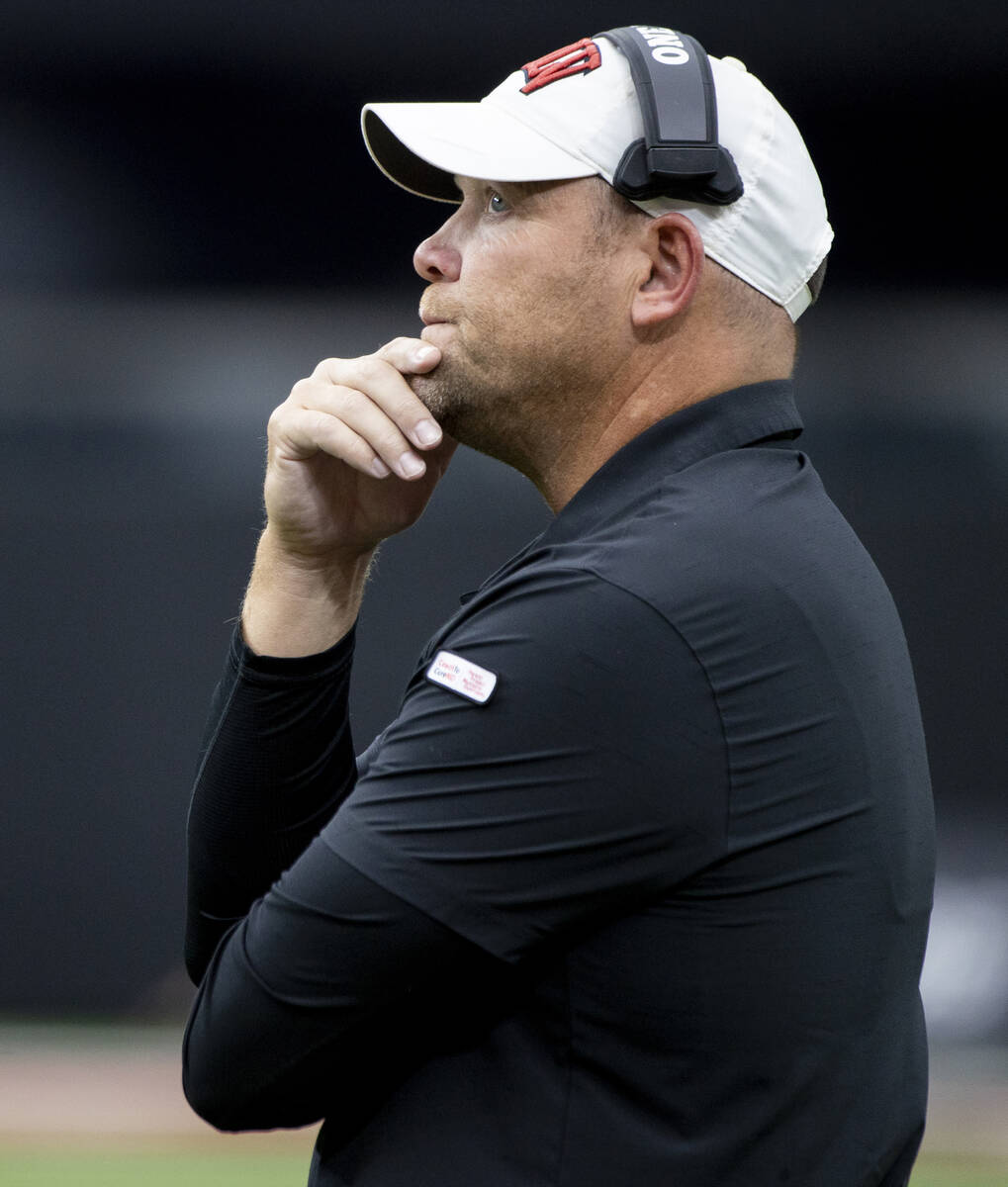 UNLV football coach Barry Odom watches the big screen during the college football game against ...