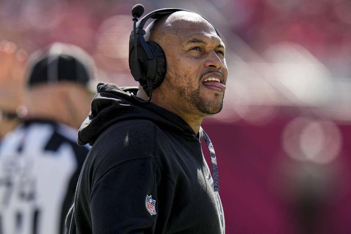 Las Vegas Raiders head coach Antonio Pierce looks at a replay during the first half of an NFL f ...