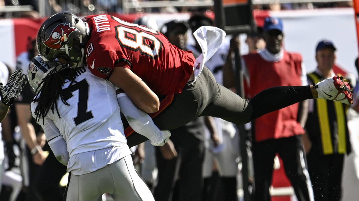 Tampa Bay Buccaneers tight end Cade Otton (88) makes the catch against Las Vegas Raiders safety ...