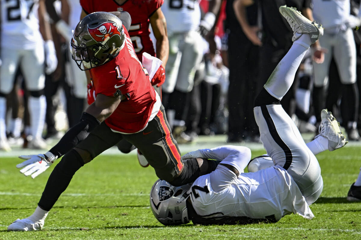 Las Vegas Raiders safety Tre'von Moehrig (7) tackles Tampa Bay Buccaneers running back Rachaad ...